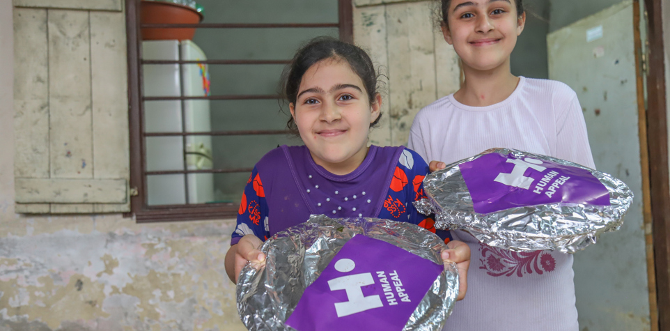 Girls holding hot iftar meals